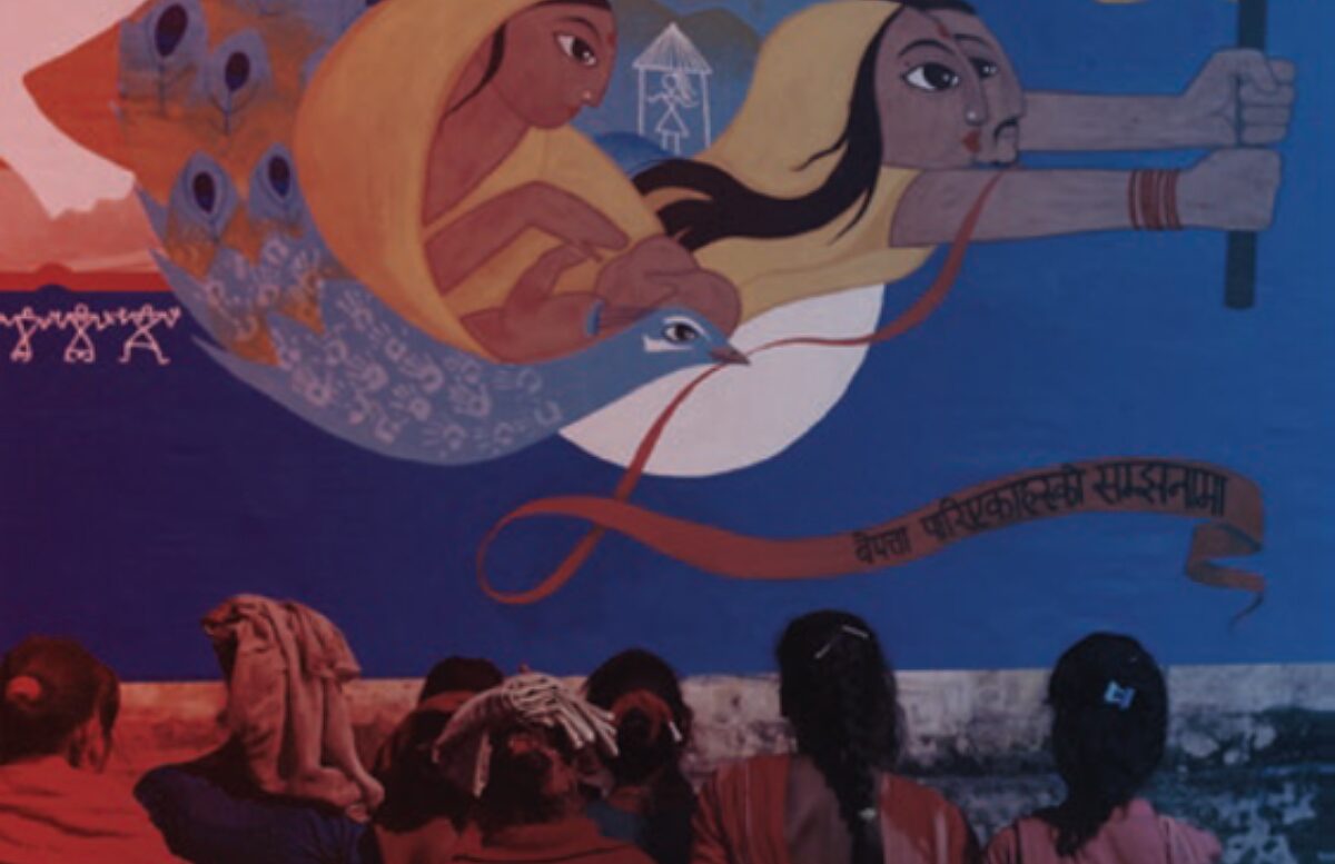 Women viewing We Search for Truth, a collaborative mural created by Martin Travers and women affected by enforced disappearance in Bardiya, Nepal.